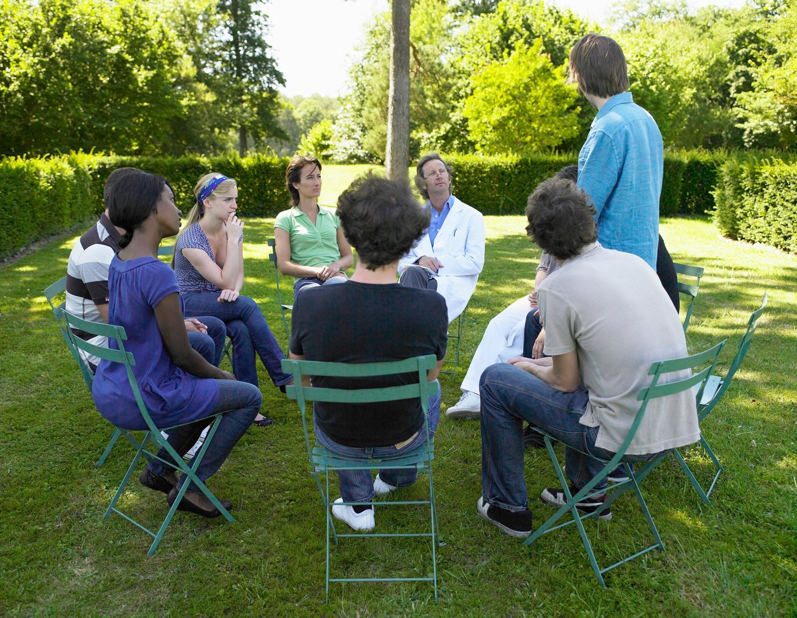 Circle of people in rehab, outdoors