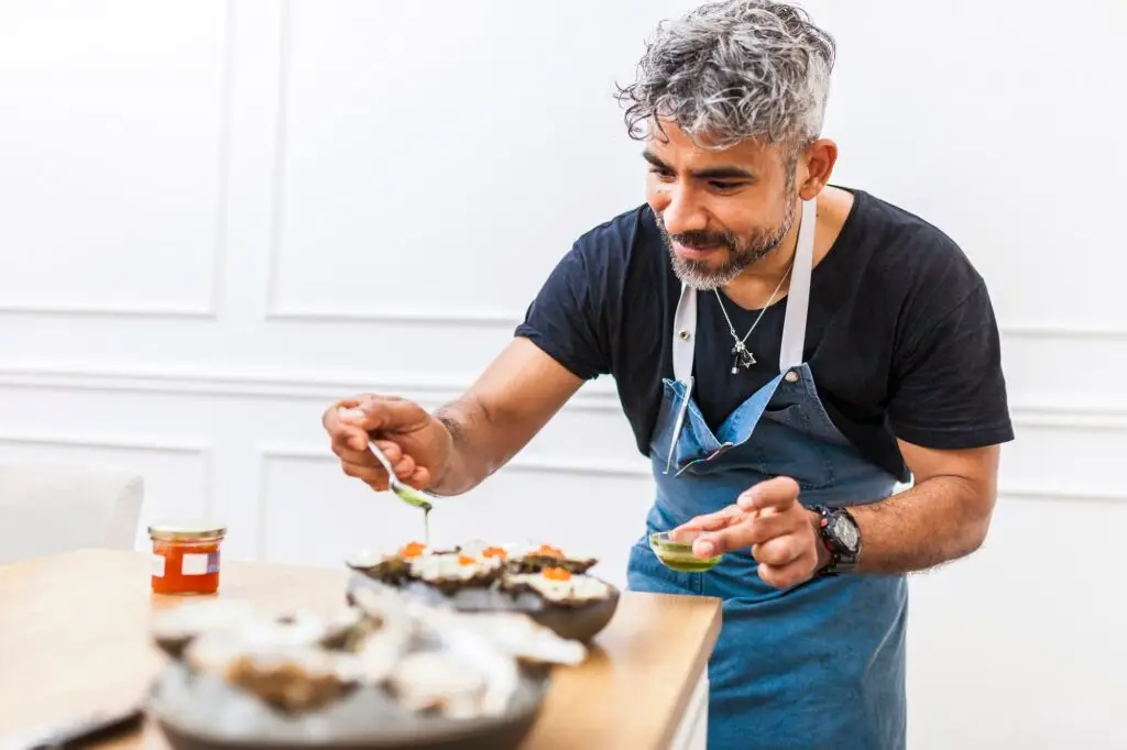 Latin american chef cooking oysters at home